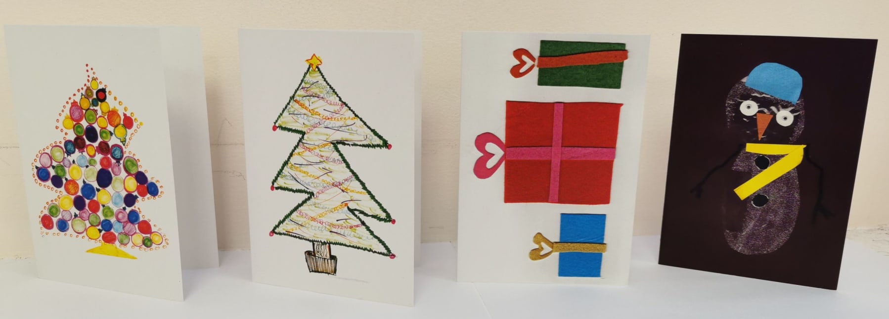Image shows four christmas card designs. 